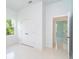 Bright bedroom with white tile floors, a large window, and a double-door closet at 398 Sunset N Rd, Rotonda West, FL 33947