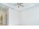 Empty bedroom with a ceiling fan, tile floor, and a view to the bathroom at 398 Sunset N Rd, Rotonda West, FL 33947