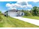 Beautiful single-story home features a well-manicured lawn, long driveway, and attached two car garage at 398 Sunset N Rd, Rotonda West, FL 33947