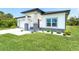 Striking, modern home with lush green lawn and tasteful landscaping at 398 Sunset N Rd, Rotonda West, FL 33947