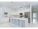 Bright, open kitchen with stainless steel appliances, large island and modern pendant lights at 398 Sunset N Rd, Rotonda West, FL 33947