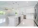 Open kitchen with stainless steel appliances, large island with wine cooler, and modern lighting at 398 Sunset N Rd, Rotonda West, FL 33947