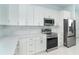 Kitchen featuring modern appliances, tile backsplash, and ample counter space at 398 Sunset N Rd, Rotonda West, FL 33947