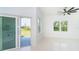 Bright living room featuring an outdoor patio, tile flooring, and a ceiling fan at 398 Sunset N Rd, Rotonda West, FL 33947