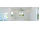 Bright living room with tile floors, large windows and a sliding door to the patio at 398 Sunset N Rd, Rotonda West, FL 33947