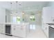 Open floor plan with a view of the island kitchen and sliding glass doors to the outdoor space at 398 Sunset N Rd, Rotonda West, FL 33947