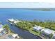 Aerial view showcases waterfront property, community access, and beautiful blue ocean water at 4219 Spire St, Port Charlotte, FL 33981