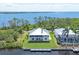 An aerial view showcases the home's waterfront location with mature landscaping and private dock at 4219 Spire St, Port Charlotte, FL 33981