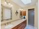 Bathroom featuring double sinks, decorative mirrors, and a walk-in shower at 4219 Spire St, Port Charlotte, FL 33981