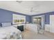 Bright bedroom with two twin beds, blue walls and access to a balcony at 4219 Spire St, Port Charlotte, FL 33981