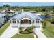 Stunning elevated home features a metal roof, two-car garage, and beautiful landscaping and water access at 4219 Spire St, Port Charlotte, FL 33981