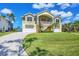 Charming two-story home features a lush green lawn and convenient two-car garage at 4219 Spire St, Port Charlotte, FL 33981