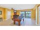 Entertaining game room featuring a pool table, wet bar, and bright yellow walls at 4219 Spire St, Port Charlotte, FL 33981