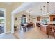 Bright eat-in kitchen with cherry wood cabinets, tile floors, bar seating and sliding glass doors to deck at 4219 Spire St, Port Charlotte, FL 33981