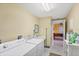 Functional laundry room includes washer, dryer, utility sink, and ample storage space at 4219 Spire St, Port Charlotte, FL 33981