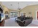 Large living room with fireplace, comfy leather sofa, ceiling fan and screened patio access at 4219 Spire St, Port Charlotte, FL 33981