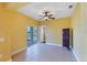Neutral living room featuring tile floors, a ceiling fan, and patio access at 4219 Spire St, Port Charlotte, FL 33981