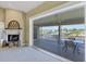 Bright living room features a fireplace and sliding door access to the screened patio with water views at 4219 Spire St, Port Charlotte, FL 33981