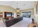 Spacious living room features a large leather sofa, fireplace, and sliding doors to the screened in patio at 4219 Spire St, Port Charlotte, FL 33981