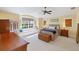 Sun-filled bedroom featuring a window seat, ceiling fan, and wood furnishings at 4219 Spire St, Port Charlotte, FL 33981
