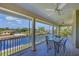 Relaxing screened-in patio boasts ceiling fans and views of the water and neighboring homes at 4219 Spire St, Port Charlotte, FL 33981