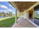 A covered patio with travertine tile overlooks the canal and waterfront property at 4219 Spire St, Port Charlotte, FL 33981