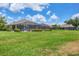Lush backyard offering ample space for outdoor activities and relaxation with screened in lanai at 4225 Fairway Dr, North Port, FL 34287