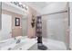 This bathroom features a shower and tub combo, vanity, and a neutral color scheme for a relaxing and clean aesthetic at 4225 Fairway Dr, North Port, FL 34287