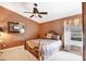 This warm bedroom features a ceiling fan, window, and a comfortable bed, perfect for relaxation and rest at 4225 Fairway Dr, North Port, FL 34287