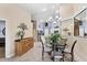 Dining area with chandelier, table, chairs, sideboard, and a decorative mirror, perfect for Gathering meals and gatherings at 4225 Fairway Dr, North Port, FL 34287