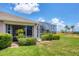Home exterior featuring a screened lanai and in-ground pool, plus a lush green lawn at 4225 Fairway Dr, North Port, FL 34287