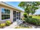 Side view of home featuring a screened entryway, and walkway lined with attractive landscaping at 4225 Fairway Dr, North Port, FL 34287