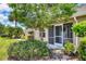 Charming single-story home with screened front porch and lush landscaping at 4225 Fairway Dr, North Port, FL 34287