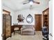 Home office area with custom wood cabinets and desk, a cozy seating area and natural light at 4225 Fairway Dr, North Port, FL 34287