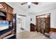 This is a home office with carpet and custom cabinets that is set up for both work and relaxation at 4225 Fairway Dr, North Port, FL 34287