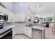 Bright kitchen with stainless appliances, tile backsplash, and a breakfast bar overlooking the living room at 4225 Fairway Dr, North Port, FL 34287