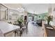 Bright living room featuring tile floors, neutral paint, an elegant chandelier, and sliding glass doors to the outside at 4225 Fairway Dr, North Port, FL 34287