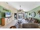 Spacious living room with high ceilings, tile flooring, and sliding door access to lanai at 4225 Fairway Dr, North Port, FL 34287