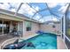 Beautiful pool with a unique layout, in screened enclosure, and outdoor seating area at 4225 Fairway Dr, North Port, FL 34287