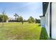 Large backyard with lush lawn and tropical landscaping creating a private outdoor space, perfect for relaxation and entertainment at 482 Sunset N Rd, Rotonda West, FL 33947
