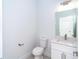A clean half-bathroom with modern fixtures including a toilet, sink, and a mirror at 482 Sunset N Rd, Rotonda West, FL 33947