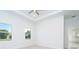 Bright bedroom with tray ceiling, tile flooring, and natural light at 482 Sunset N Rd, Rotonda West, FL 33947