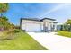 Beautiful one-story home with lush lawn, attached two-car garage, and well-maintained landscaping at 482 Sunset N Rd, Rotonda West, FL 33947