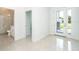 Open foyer featuring tile flooring, neutral walls, glass door to the bathroom, and a glass front door at 482 Sunset N Rd, Rotonda West, FL 33947