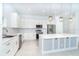 Modern kitchen featuring white cabinetry, stainless steel appliances, and an island at 482 Sunset N Rd, Rotonda West, FL 33947