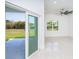 Bright living room with tile floors, modern ceiling fan and sliding door to patio at 482 Sunset N Rd, Rotonda West, FL 33947