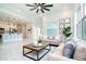 This staged living room offers an open layout to the kitchen and an abundance of natural light at 482 Sunset N Rd, Rotonda West, FL 33947