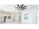 Bright, open living room with modern lighting and sleek tile flooring leading to the kitchen area at 482 Sunset N Rd, Rotonda West, FL 33947
