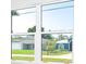 A clear view of neighboring homes from a window showcases the community at 482 Sunset N Rd, Rotonda West, FL 33947