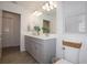 Spacious bathroom featuring a double sink vanity with white countertops and wood-look tile at 5009 Skyview Ln, Bradenton, FL 34211